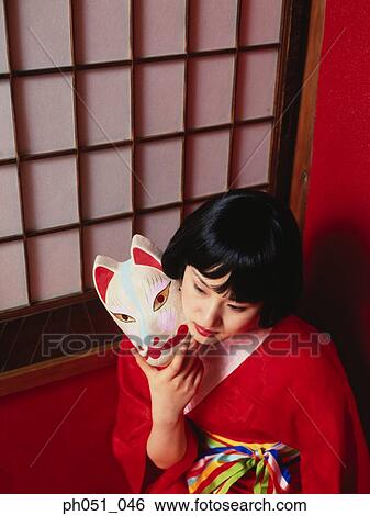 Japanese woman in kimono holding a mask View Large Photo Image Stock Photograph - Japanese woman in kimono holding a mask. Fotosearch
