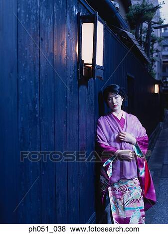 Japanese woman in kimono leaning against wall View Large Photo Image Stock Photo - Japanese woman in kimono leaning against wall. Fotosearch