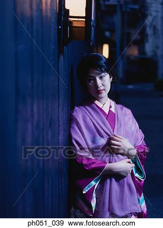 Japanese woman in kimono leaning against wall View Large Photo Image Stock Photo - Japanese woman in kimono leaning against wall. Fotosearch