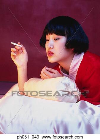 Japanese woman in kimono with cigarette View Large Photo Image Stock Photo - Japanese woman in kimono with cigarette. Fotosearch