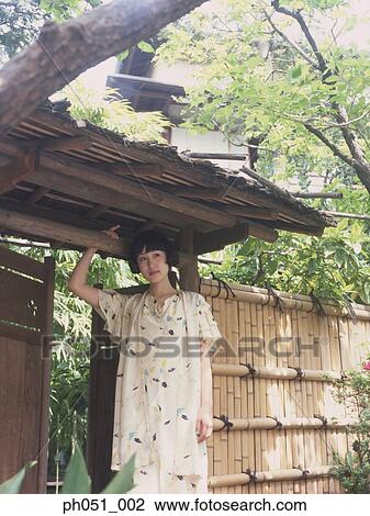 Stock Image - Woman in Japanese garden. Fotosearch