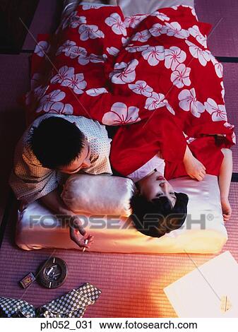 Japanese couple on bed, man with cigarette View Large Photo Image Stock Image - Japanese couple on bed, man with cigarette. Fotosearch