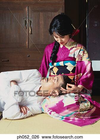 Stock Photograph - Japanese man lying on woman's lap . Fotosearch