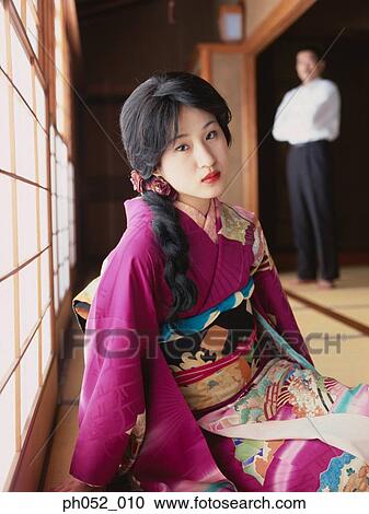 Stock Image - Japanese woman and man (focus on Japanese woman in kimono). Fotosearch