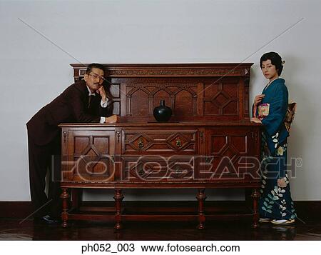 Japanese woman in kimono removing man's jacket View Large Photo Image Stock Image - Japanese woman in kimono removing man's jacket. Fotosearch