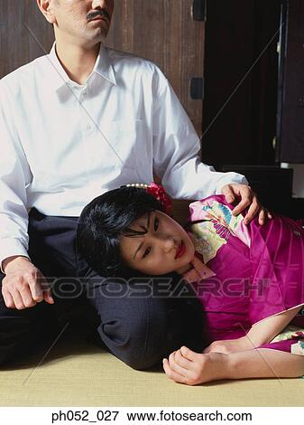 Stock Photo - Japanese woman sleeping on man's lap . Fotosearch