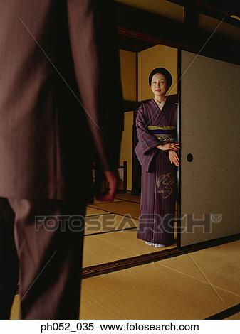 Japanese woman standing in doorway, welcoming man View Large Photo Image Stock Photography - Japanese woman standing in doorway, welcoming man. Fotosearch