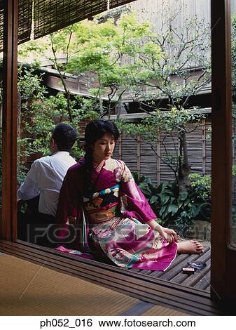 Stock Photograph - Traditional Japanese couple at backyard garden. Fotosearch