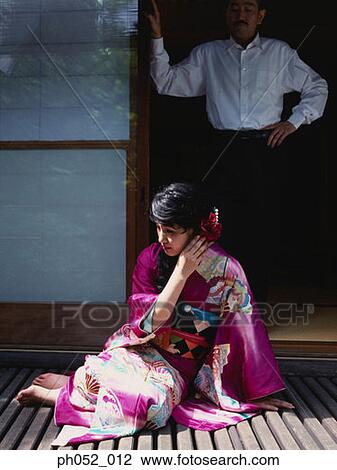 Stock Image - Traditional Japanese couple by the door. Fotosearch