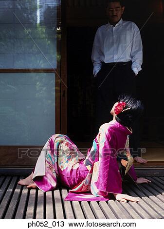 Stock Image - Traditional Japanese couple by the door. Fotosearch