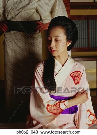 Stock Image - Traditional Japanese couple, indoor . Fotosearch