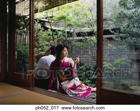 Traditional Japanese couple smoking in backyard garden View Large Photo Image Stock Photo - Traditional Japanese couple smoking in backyard garden. Fotosearch