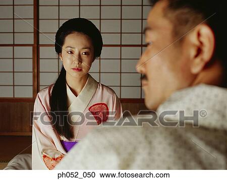 Traditional Japanese couple, view over man's shoulder View Large Photo Image Stock Image - Traditional Japanese couple, view over man's shoulder . Fotosearch