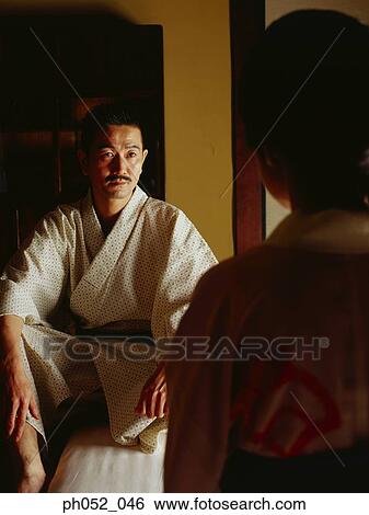 Stock Photograph - Traditional Japanese couple, view over woman's shoulder . Fotosearch