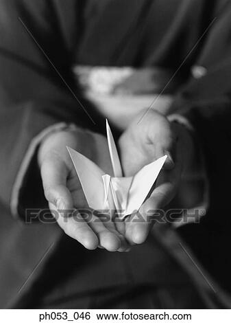 Hands holding origami crane View Large Photo Image Stock Photograph - Hands holding origami crane. Fotosearch
