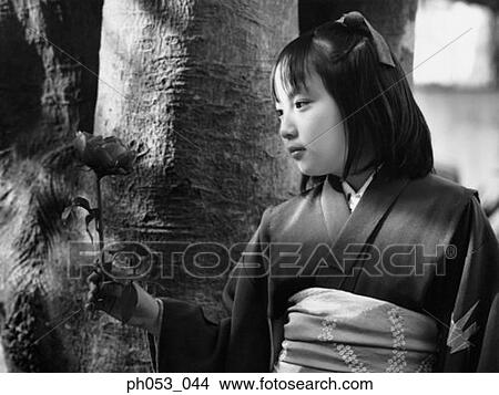 Japanese girl in kimono holding a stalk of flower View Large Photo Image Picture - Japanese girl in kimono holding a stalk of flower. Fotosearch