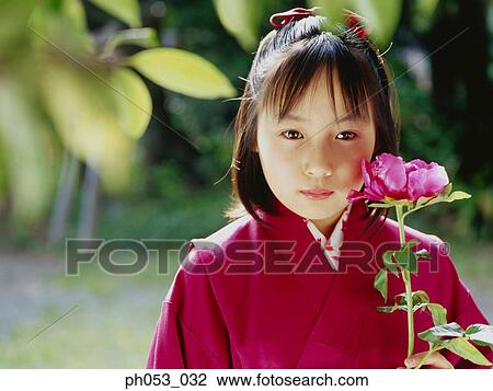 Japanese girl in kimono holding a stalk of flower View Large Photo Image Stock Image - Japanese girl in kimono holding a stalk of flower. Fotosearch