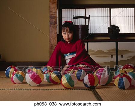 Stock Photo - Japanese girl in kimono, paper balls on floor. Fotosearch