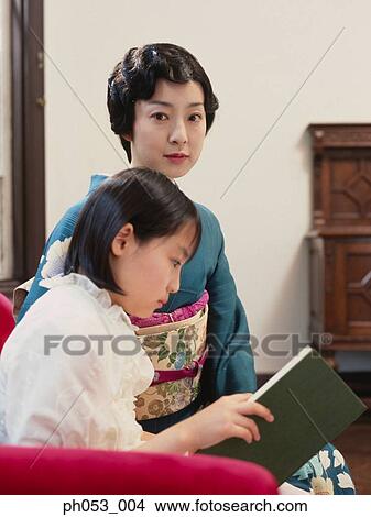 Picture - Mother and daughter reading . Fotosearch