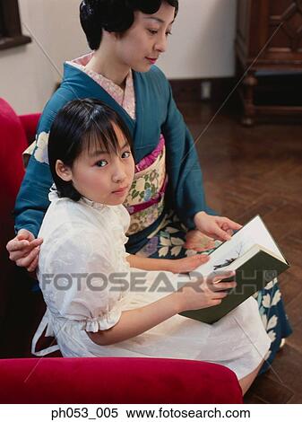 Mother and daughter reading View Large Photo Image Stock Photography - Mother and daughter reading . Fotosearch