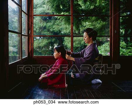 Mother combing for daughter, both in kimono View Large Photo Image Picture - Mother combing for daughter, both in kimono. Fotosearch
