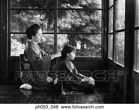 Mother combing for daughter, both in kimono View Large Photo Image Stock Photo - Mother combing for daughter, both in kimono. Fotosearch