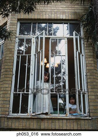 Two girls at window ledge by open window View Large Photo Image Stock Photograph - Two girls at window ledge by open window. Fotosearch