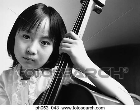 Young girl holding bass instrument View Large Photo Image Stock Image - Young girl holding bass instrument . Fotosearch