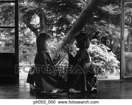 Stock Image - Young girls in Kimono playing games. Fotosearch