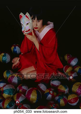 Japanese woman in kimono holding a mask View Large Photo Image Stock Image - Japanese woman in kimono holding a mask. Fotosearch