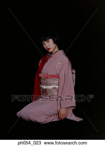 Stock Image - Japanese woman in kimono sitting on floor. Fotosearch