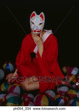 Picture - Japanese woman in kimono wearing a mask. Fotosearch
