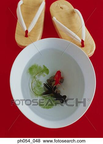 Stock Photo - Two goldfish in bowl and Japanese Geta. Fotosearch