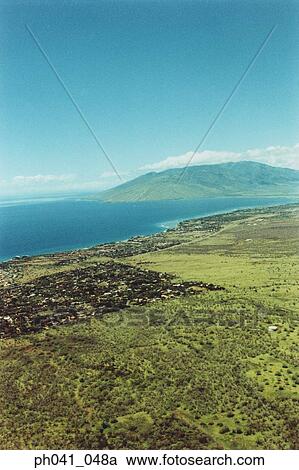 Stock Image - Aerial over land of Maui, Hawaii . Fotosearch