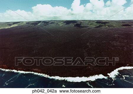 Stock Image - Aerial view of volcanic landscape and coast, Big Island, Hawaii. Fotosearch