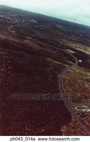 Stock Image - USA, Hawaii, Big Island, highway on lava field, aerial view . Fotosearch