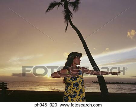 A female hula dancing outdoors near the ocean at sunset View Large Photo Image Stock Image - A female hula dancing outdoors near the ocean at sunset. Fotosearch