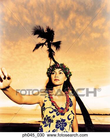 A female hula dancing outdoors near the ocean at sunset View Large Photo Image Stock Image - A female hula dancing outdoors near the ocean at sunset. Fotosearch