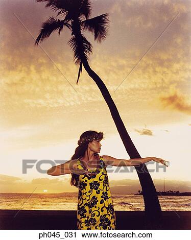 A female hula dancing outdoors near the ocean at sunset View Large Photo Image Stock Image - A female hula dancing outdoors near the ocean at sunset. Fotosearch