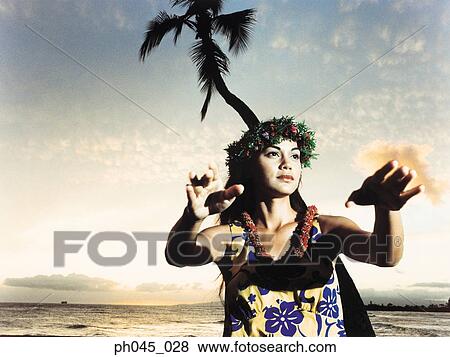 A female hula dancing outdoors near the ocean at sunset View Large Photo Image Stock Photo - A female hula dancing outdoors near the ocean at sunset. Fotosearch