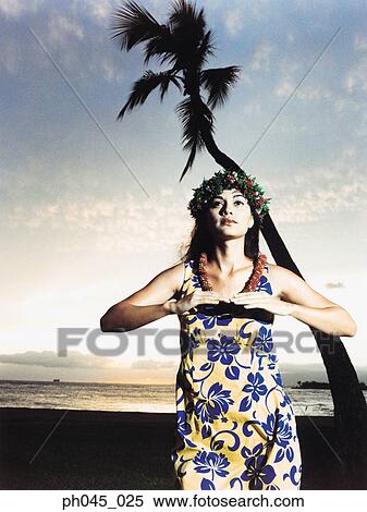 A female hula dancing outdoors near the ocean at sunset View Large Photo Image Stock Photography - A female hula dancing outdoors near the ocean at sunset. Fotosearch