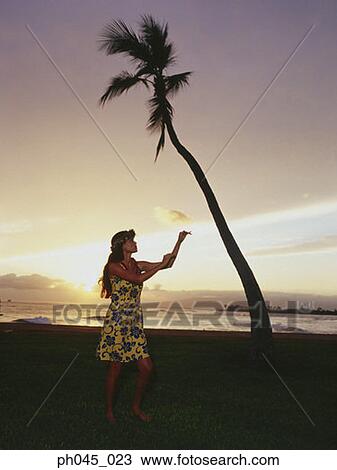 Stock Image - Hawaiian woman dancing at sunset . Fotosearch