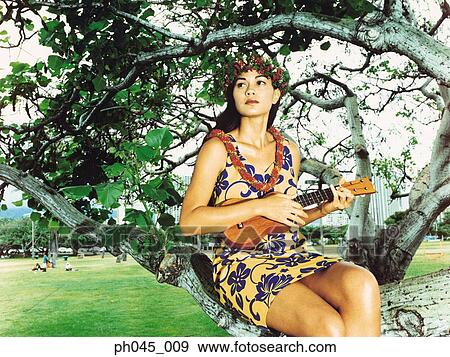 Stock Photo - Hula Dancer Playing Ukelele . Fotosearch