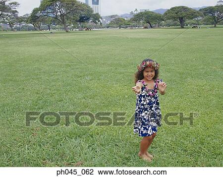 Little hula girl dancing at the field View Large Photo Image Stock Image - Little hula girl dancing at the field. Fotosearch