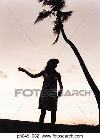Silhouette of a female hula dancing outdoors at sunset. View Large Photo Image Stock Image - Silhouette of a female hula dancing outdoors at sunset. . Fotosearch