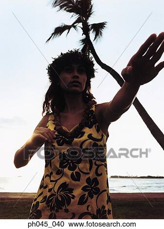 Silhouette of a female hula dancing outdoors at sunset. View Large Photo Image Stock Image - Silhouette of a female hula dancing outdoors at sunset. . Fotosearch