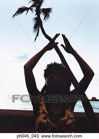 Silhouette of a female hula dancing outdoors at sunset. View Large Photo Image Stock Image - Silhouette of a female hula dancing outdoors at sunset. . Fotosearch