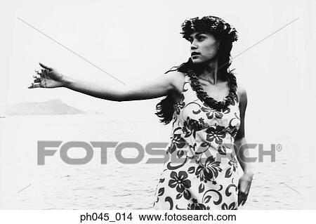 USA, Hawaii, female hula dancer performing near ocean (B&W) View Large Photo Image Picture - USA, Hawaii, female hula dancer performing near ocean (B&W). Fotosearch