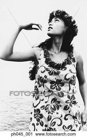 Stock Image - USA, Hawaii, female hula dancer performing near ocean (B&W) . Fotosearch