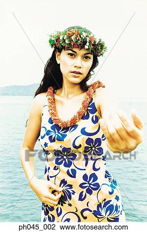 Stock Image - USA, Hawaii, female hula dancer performing near ocean . Fotosearch